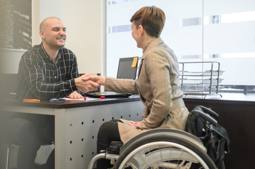 woman sitting wheelchair shaking hands NDIS in Victoria